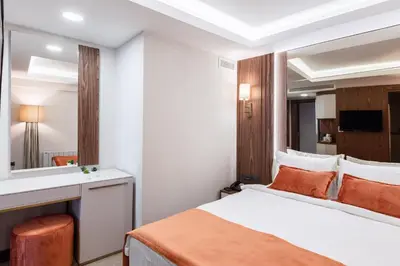a hotel room with a bed and a mirror at Sherry Suites Karaköy in Istanbul