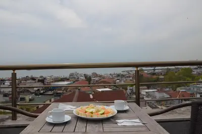 a bowl of fruit on a table on a balcony at The Reina Hotel in Istanbul