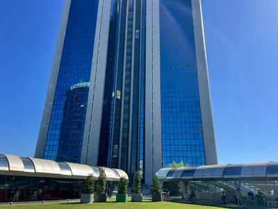 a large glass building with trees in front of it at Akmerkez Residence in Istanbul