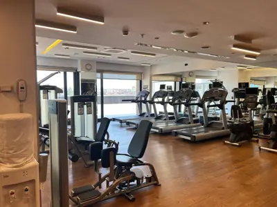 a gym with rows of treadmills and elliptical machines at Akmerkez Residence in Istanbul