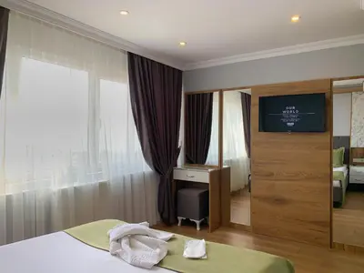 a bedroom with a bed and a desk and a television at Sultanahmet Nu Hotel in Istanbul