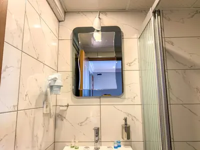a bathroom with a mirror and a sink at Sultanahmet Nu Hotel in Istanbul