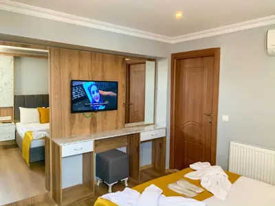 a hotel room with a desk with a tv on a wall at Sultanahmet Nu Hotel in Istanbul