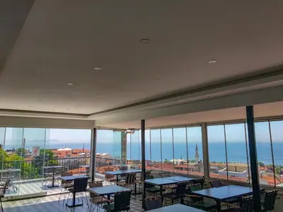 a room with tables and chairs and a view of the ocean at Sultanahmet Nu Hotel in Istanbul