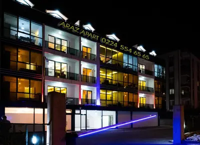 an apartment building at night with lights on it at Araz Suit in Burgaz