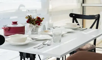 a white table with plates and utensils on it at Araz Suit in Burgaz