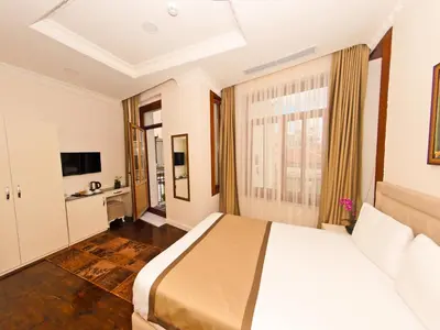 a bedroom with a large bed and a large window at Nusretbey Hotel in Istanbul