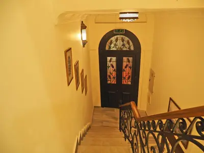 a hallway with a black door and a staircase at Nusretbey Hotel in Istanbul