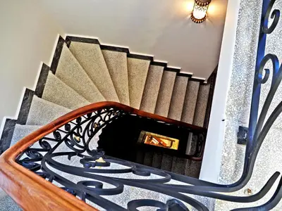 a spiral staircase in a house with a mirror at Nusretbey Hotel in Istanbul