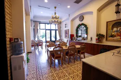 a kitchen and dining room with a table and chairs at Nusretbey Hotel in Istanbul