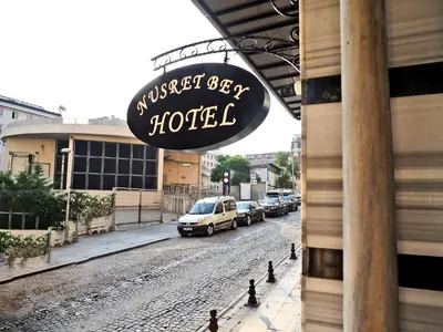 a sign for a hotel on the side of a street at Nusretbey Hotel in Istanbul