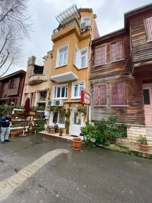 a man standing in front of a building at Masal Hotel in Buyukada