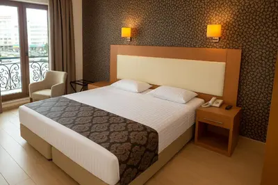 a bedroom with a large bed and a phone on a table at Grand Hotel Avcılar in Istanbul