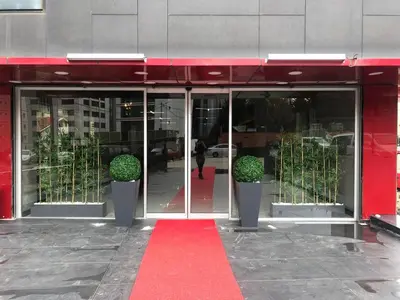 a red door of a building with a red carpet at Atacity Hotel in Istanbul