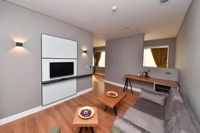 a living room with a couch and a television at Atacity Hotel in Istanbul