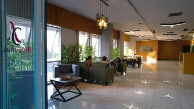 a lobby of a restaurant with people sitting in chairs at Atacity Hotel in Istanbul