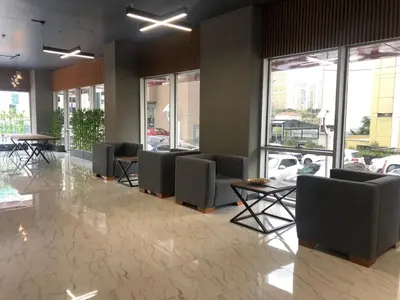 a waiting room with chairs and tables and windows at Atacity Hotel in Istanbul