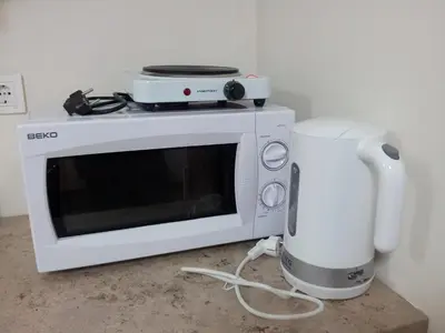 a microwave and a blender sitting on a counter at Nelly Guesthouse in Istanbul