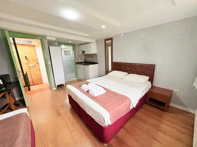 a bedroom with a large bed with white sheets at Taksim Otto suite in Istanbul