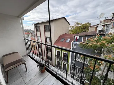 a balcony with a chair and a view of a building at Taksim Otto suite in Istanbul