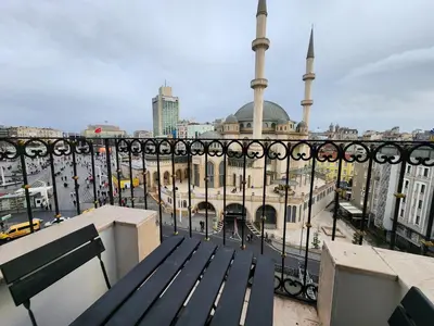 a view of a mosque from a balcony with a bench at Taksim Landhouse Hotel in Istanbul