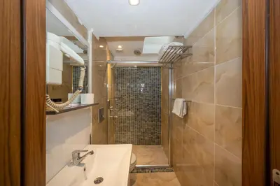 a bathroom with a shower and a sink at Tamara Residence Hotel İstanbul in Istanbul