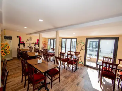 a dining room with tables and chairs and windows at Vander Valk İstanbul Hotel in Istanbul