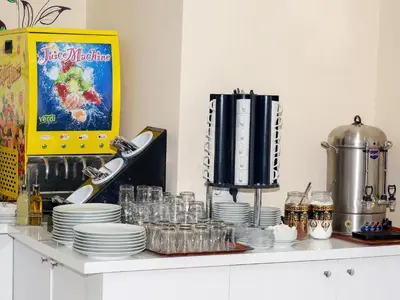 a counter with plates and glasses on a shelf at Vander Valk İstanbul Hotel in Istanbul
