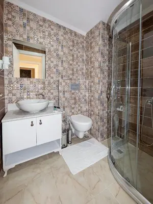 a bathroom with a toilet and a sink and a shower at Vander Valk İstanbul Hotel in Istanbul