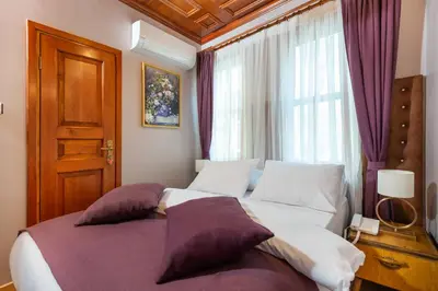 a bedroom with a large bed and a window at Wonder Wood Hotel in Istanbul