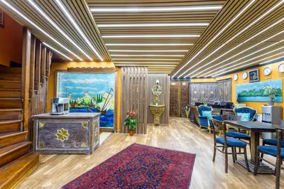 a room with a table and chairs and a room with a bed at Wonder Wood Hotel in Istanbul