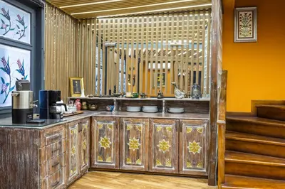 a restaurant with a kitchen with a counter and stairs at Wonder Wood Hotel in Istanbul