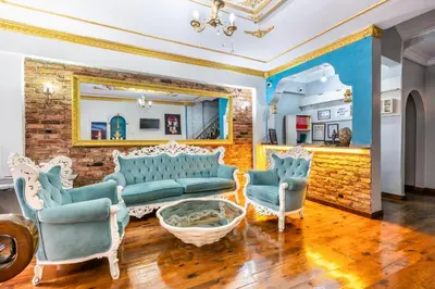 a living room with blue furniture and a brick wall at Taksim Dora Hotel in Istanbul