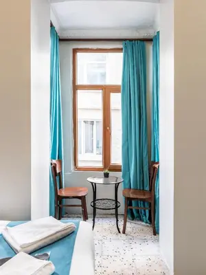 a bedroom with two beds and a table and a window at Taksim Dora Hotel in Istanbul
