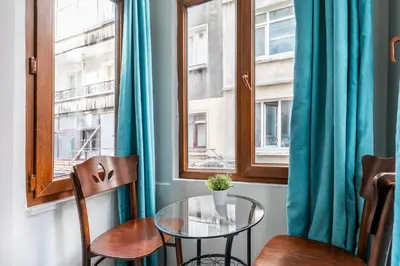 a table and chairs in a room with a window at Taksim Dora Hotel in Istanbul