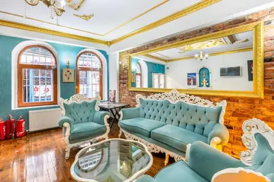 a living room with blue furniture and a mirror at Taksim Dora Hotel in Istanbul