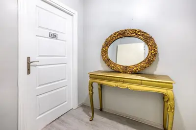 a mirror on a table next to a door at Taksim Dora Hotel in Istanbul