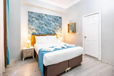 a bedroom with a bed and a painting on the wall at Taksim Dora Hotel in Istanbul