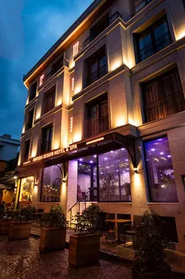 a building with a lit up facade at night at Antusa Design Hotel & Spa in Istanbul