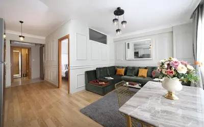 a living room with a green couch and a table at Beddington Residence Sisli in Istanbul