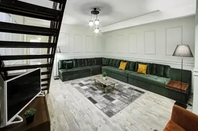 a living room with a green couch and a table at Beddington Residence Sisli in Istanbul