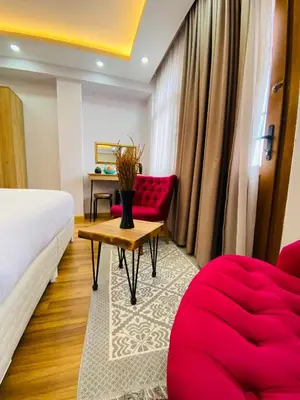 a hotel room with a bed and a red couch at PALMERA OLD CITY in Istanbul