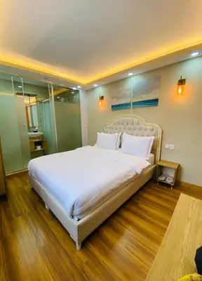 a large white bed in a room with wooden floors at PALMERA OLD CITY in Istanbul