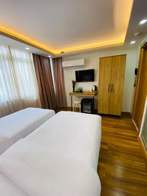 a hotel room with two beds and a desk at PALMERA OLD CITY in Istanbul