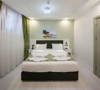 a bedroom with a large bed with white pillows at OBAHAN HOTEL-Special Class in Istanbul