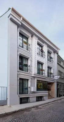 a white building with balconies on a street at OBAHAN HOTEL-Special Class in Istanbul