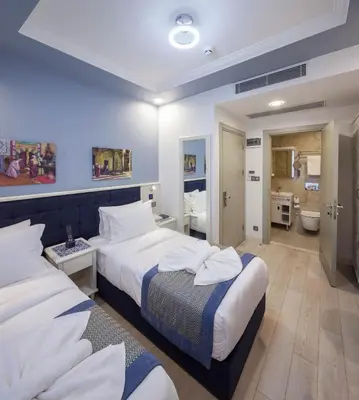 a hotel room with two beds and a bathroom at OBAHAN HOTEL-Special Class in Istanbul