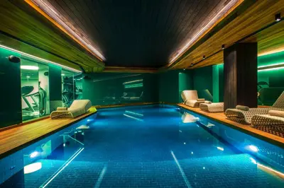 a swimming pool with chairs in a building at Lasagrada Hotel Istanbul in Istanbul