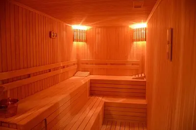 a wooden sauna with two benches and lights in it at Heybeli Garden in Bursa