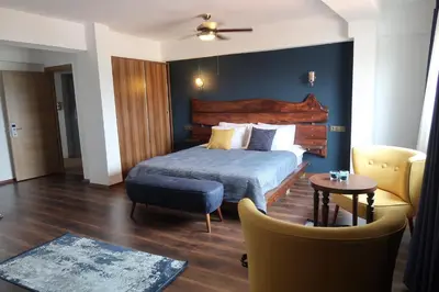 a bedroom with a bed and a table and chairs at Fuego Design Suites in Istanbul